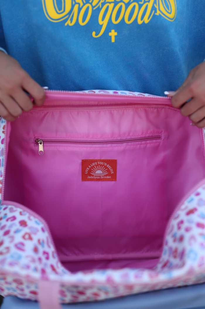 Jadelynn Brooke leopard print tote bag with pink interior and zip pocket, ideal for everyday use.