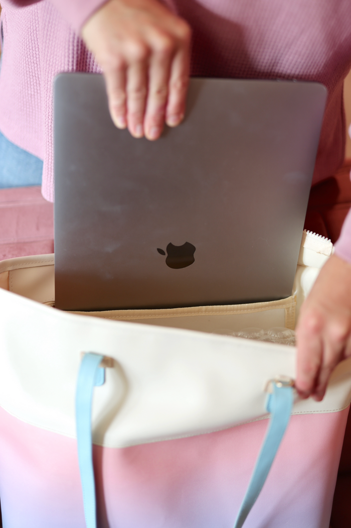 Stylish gradient laptop tote bag in pink and cream with blue accents, perfect for carrying MacBooks.