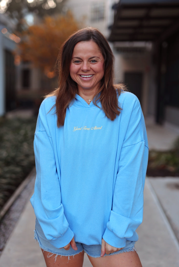 Light blue oversized hoodie with 'Good Times Ahead' embroidery, perfect for casual wear.