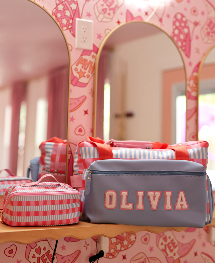 Personalized purple and pink striped cosmetic bags, perfect for storage and travel, featuring 'OLIVIA' design.