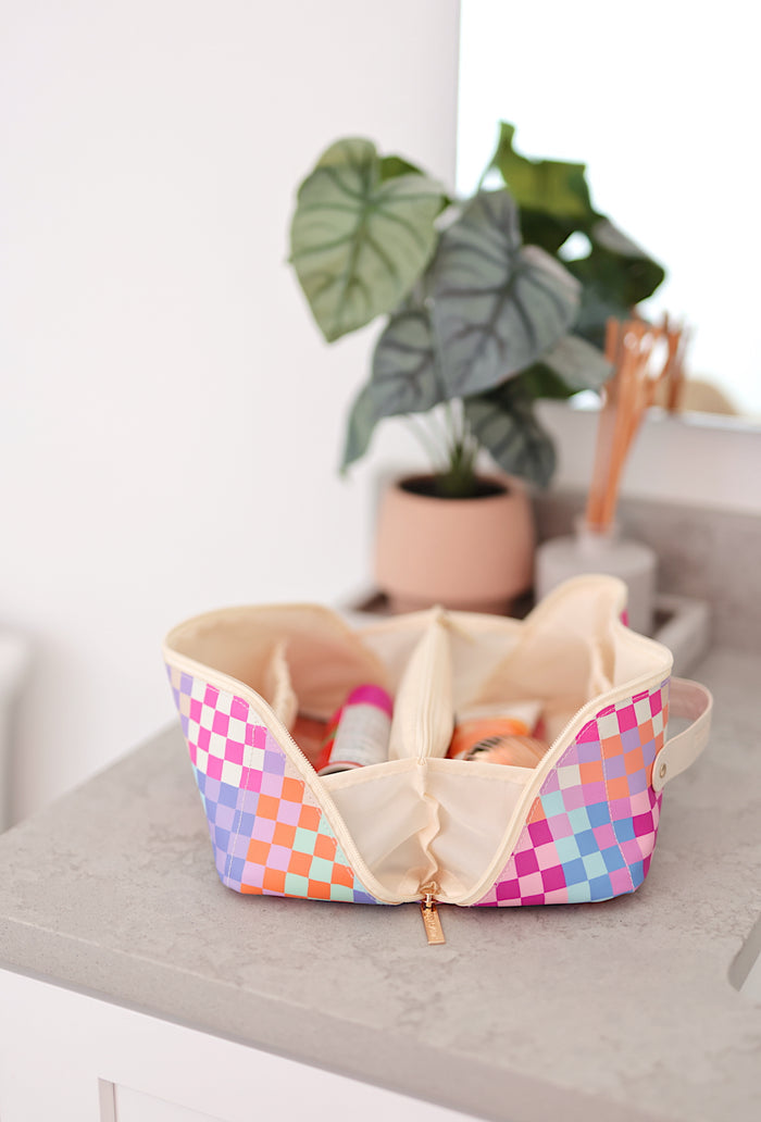 Colorful checkered makeup bag in pastel colors, spacious interior with dividers for organization.