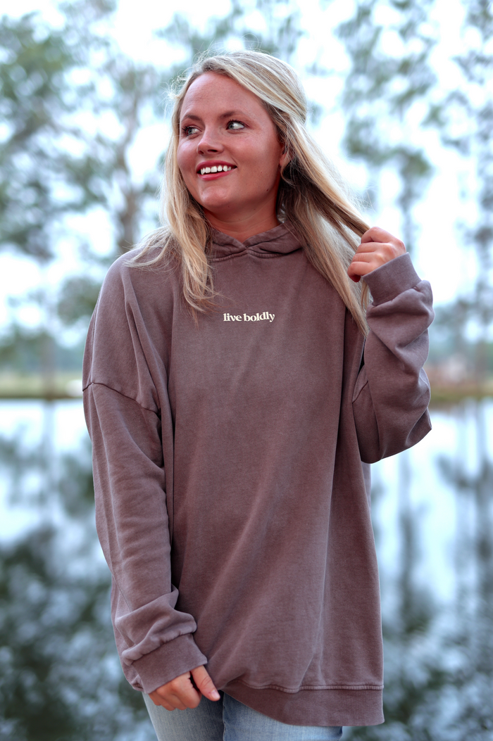 Brown oversized hoodie with 'live boldly' print, perfect for casual wear and comfort.