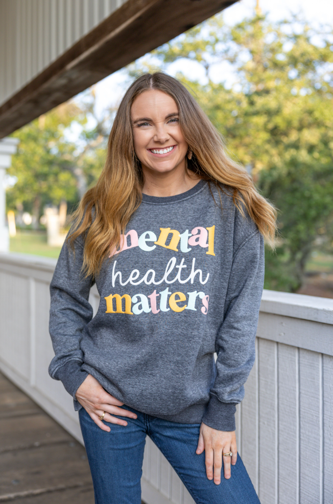 Gray sweatshirt with 'mental health matters' text, soft material, cozy fit, perfect for casual wear.