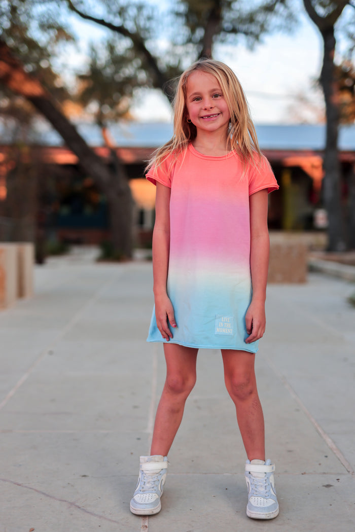 Girls' gradient dress, pink to blue, made of soft fabric, features 'Live in the Moment' print.