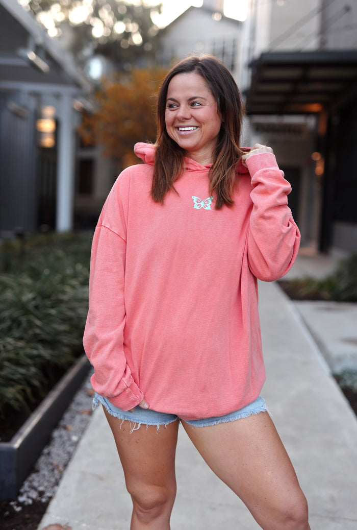 Women's coral oversized hoodie with butterfly design, made from soft cotton blend, perfect for casual wear.