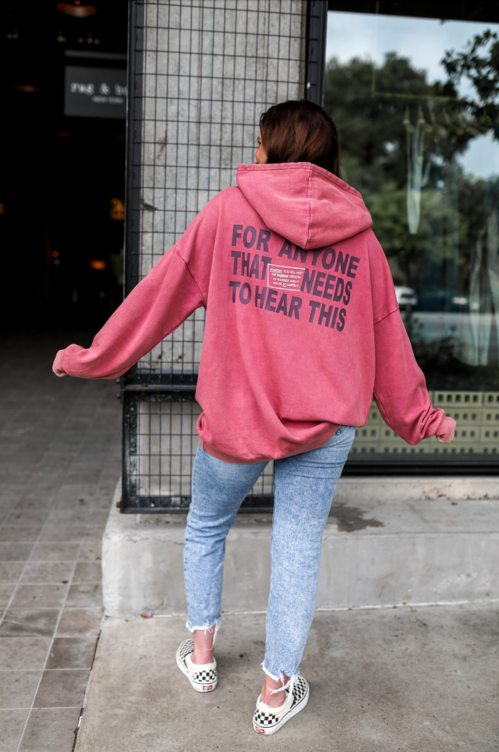 Oversized pink hoodie with slogan detail, perfect for casual wear and comfort.
