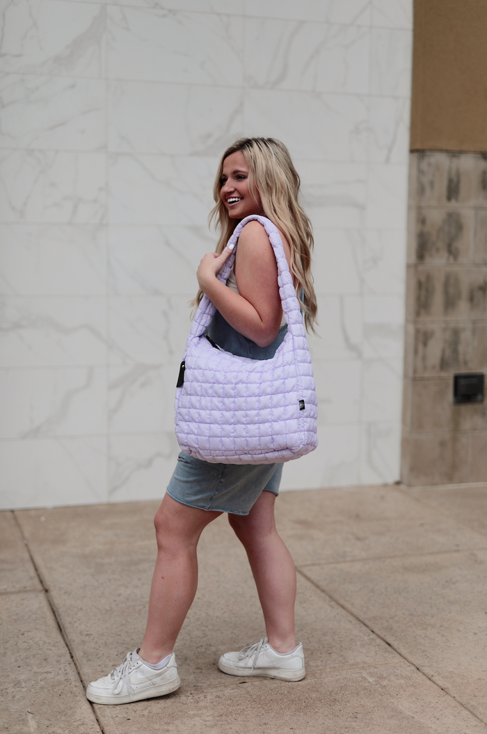 Light purple quilted handbag, stylish and durable, perfect for everyday use.