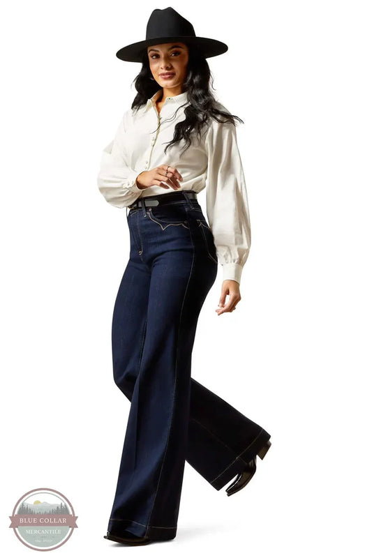 Woman wearing a white blouse, black pants, and a black hat on a white background Ariat 10065877 Ultra High Rise Veronica Wide Leg Jean