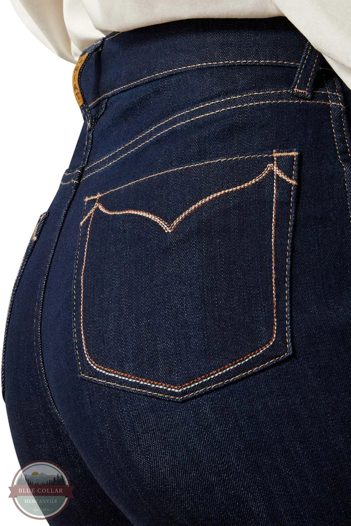 Close-up of dark blue jeans with a brand logo in the corner. Ariat 10065877 Ultra High Rise Veronica Wide Leg Jean