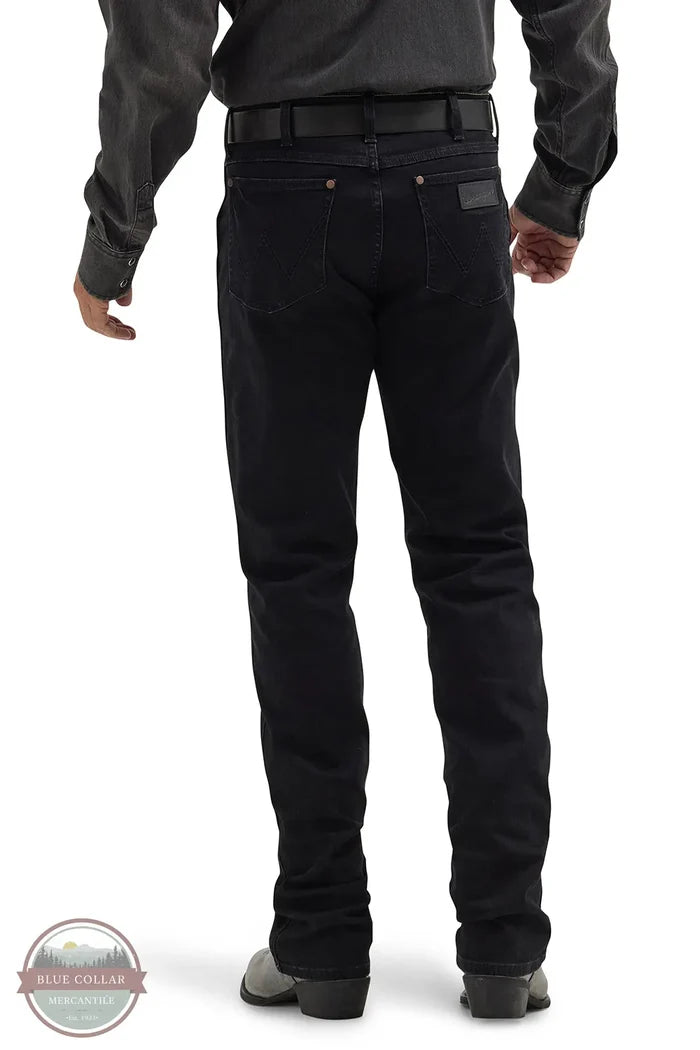 Person wearing black pants on a white background with Blue Collar logo. Wrangler 112358240 Retro Slim Fit Straight Leg Jean rear view