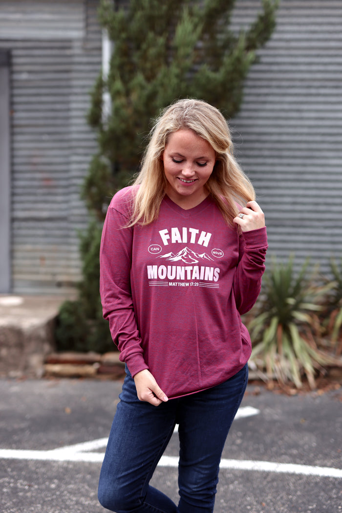 Women's maroon long-sleeve shirt with 'Faith Can Move Mountains' graphic, made from soft cotton.