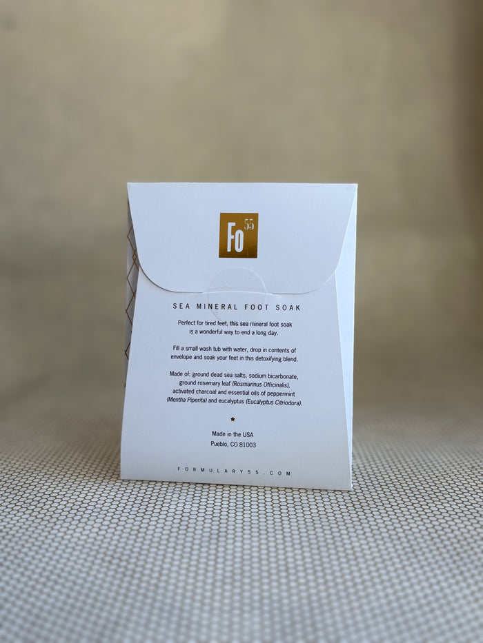 back of Formulary 55 eucalyptus and peppermint Sea Mineral foot soak in white packaging with black floral graphic.
