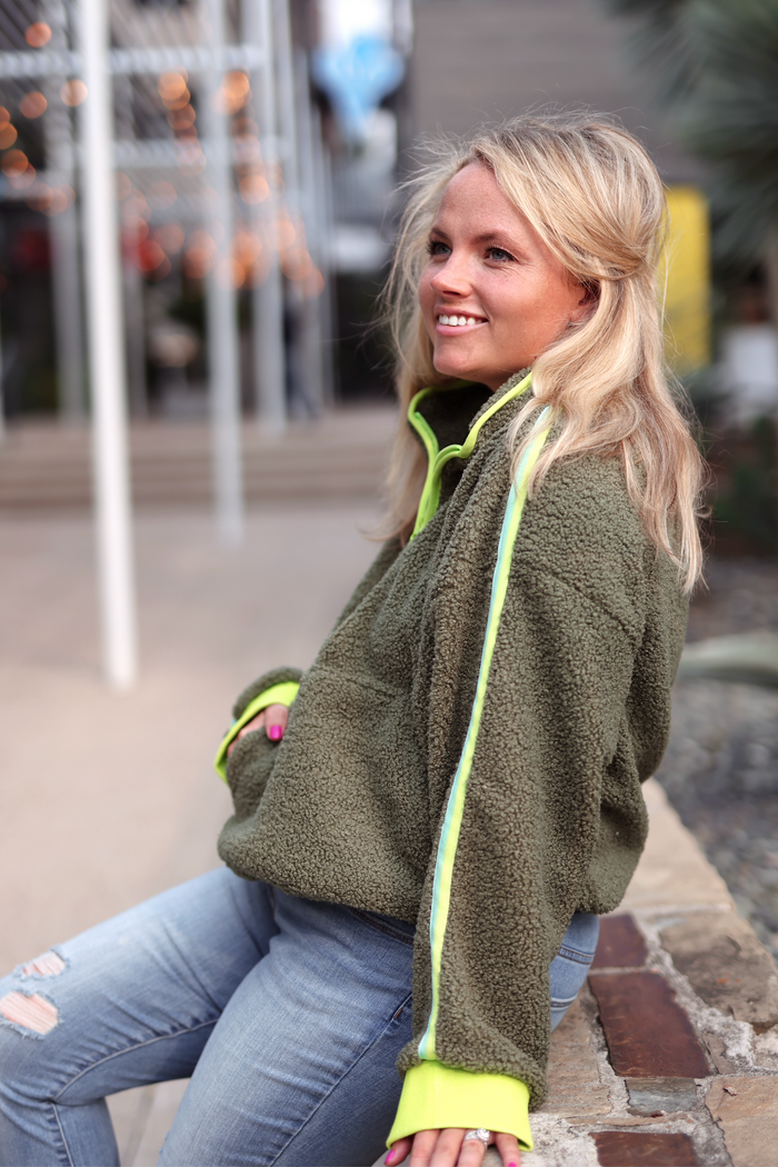 Cozy olive green fleece pullover with neon yellow accents, perfect for casual outings.