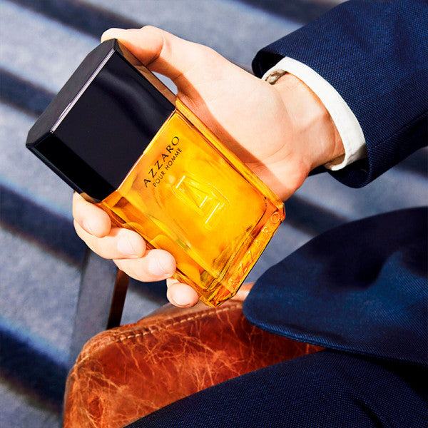 Azzaro Pour Homme Eau de Toilette amber glass fragrance bottle with a black rectangular cap and embossed front