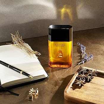 Azzaro Pour Homme Eau de Toilette in an amber glass bottle with a black cap and gold lettering
