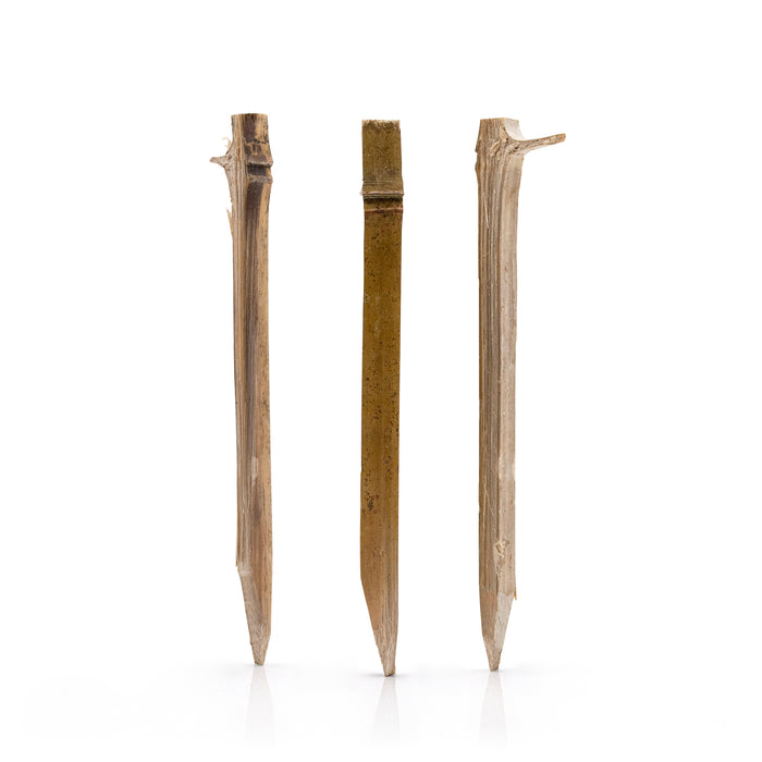 Three  bamboo pegs on a white background