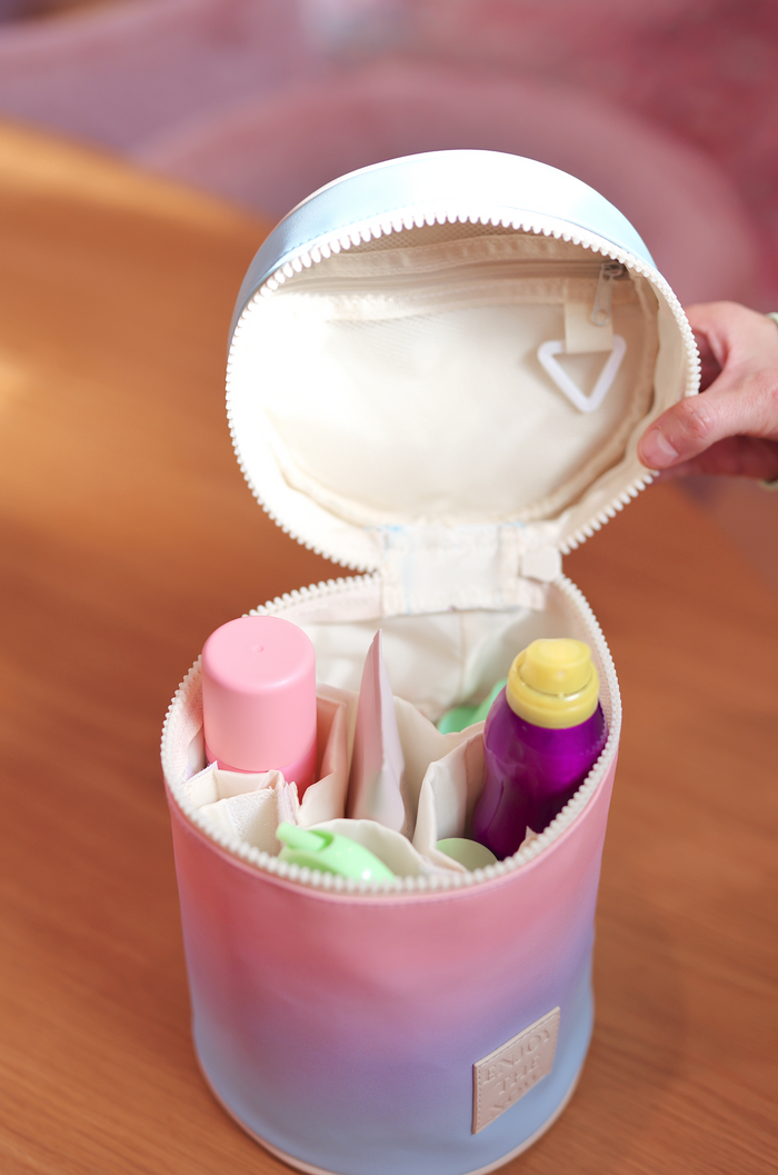 Multicolor round cosmetic bag with organized compartments, perfect for toiletries and makeup.