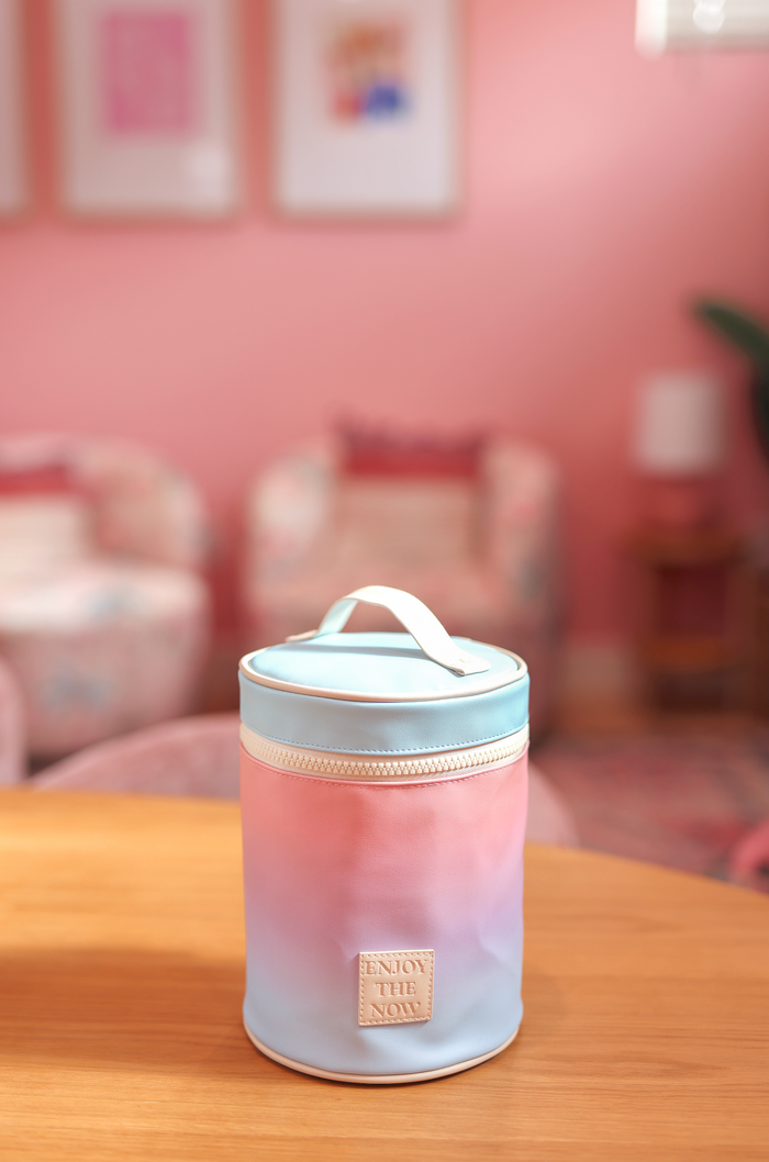 Colorful gradient storage container with zip closure and top handle, perfect for organizing essentials.