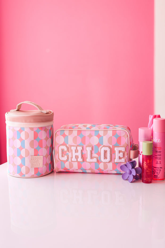 Pink circular pattern cosmetic bag set with name 'CHLOE' and flower accessory, perfect for travel.