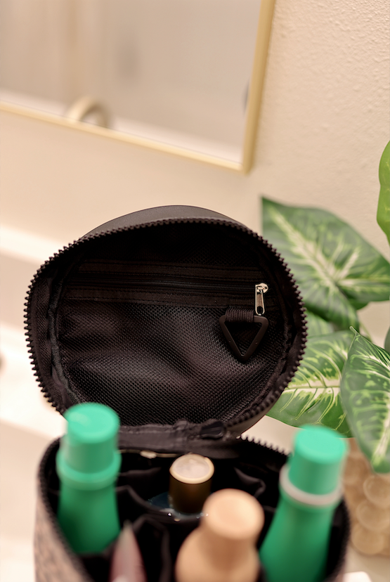 Black cosmetic bag with zippered pocket, ideal for organizing toiletries and makeup.
