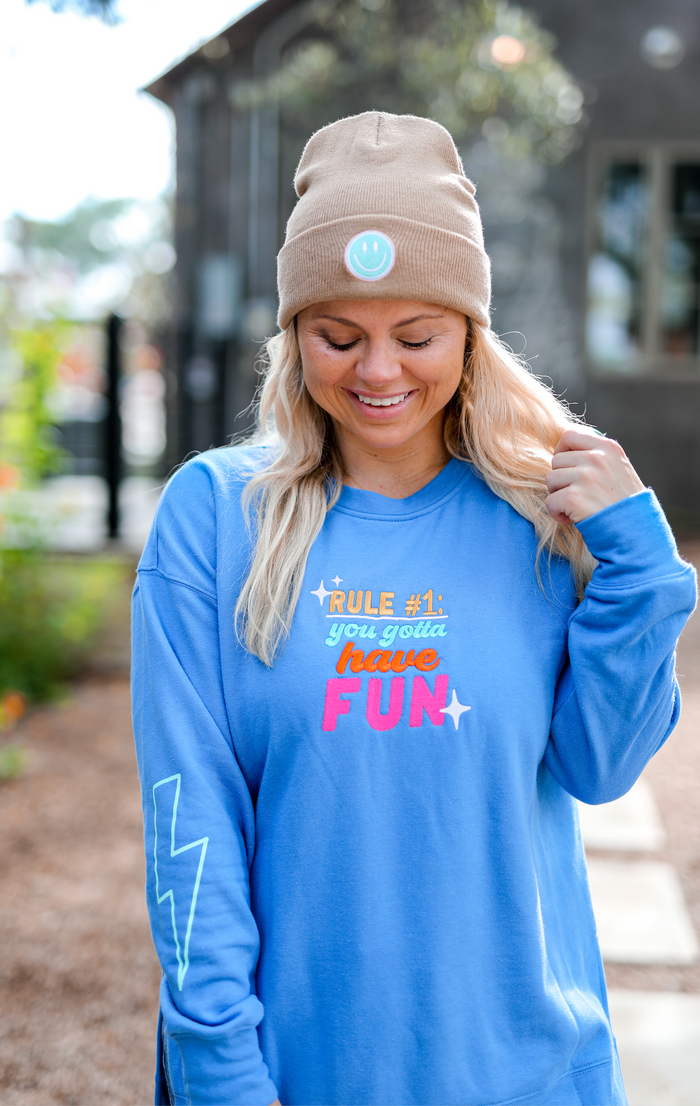 Light blue long sleeve sweatshirt with 'have FUN' graphic, perfect for casual wear and comfort.