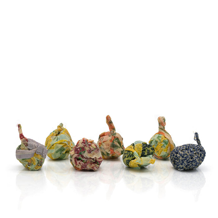 Set of 7 natural beeswax firelighters on a white background.