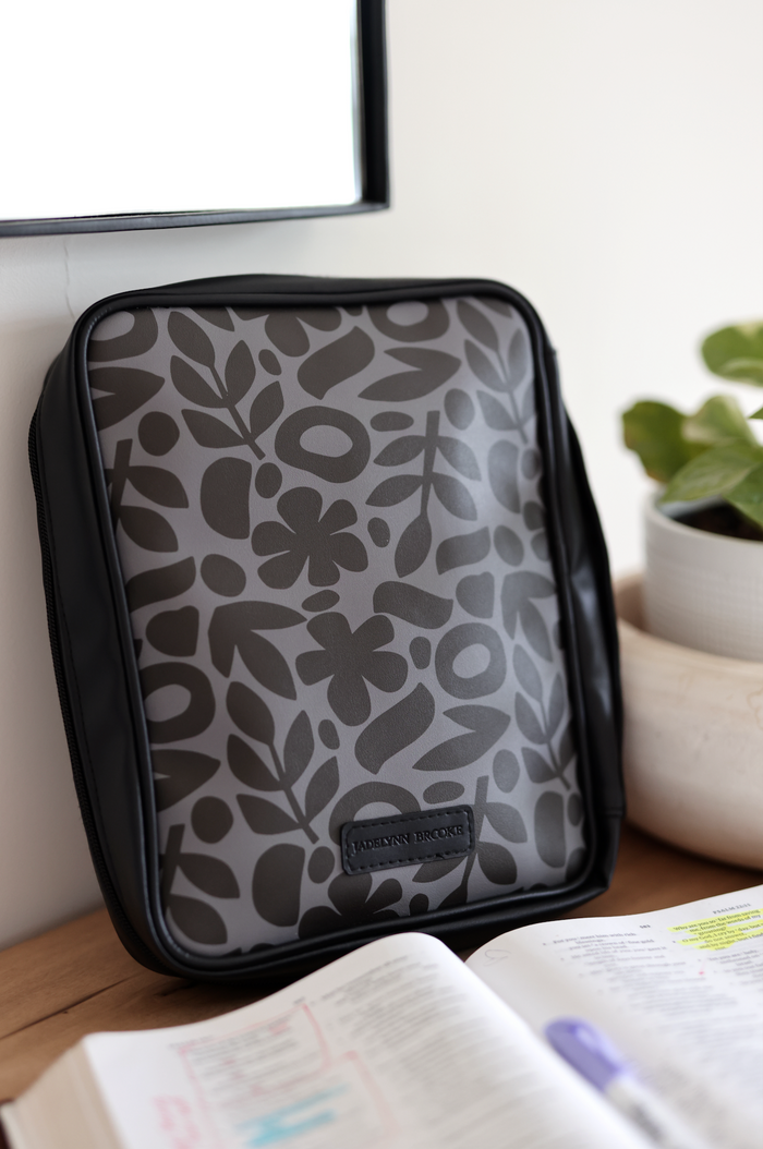 Stylish gray floral laptop sleeve with black accents, perfect for protecting your device.