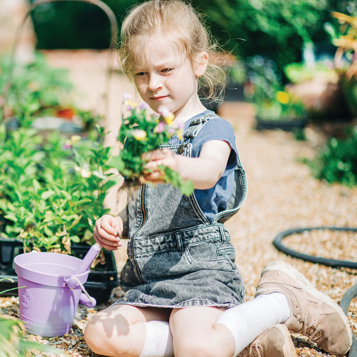Girl with plastic free bucket and spade