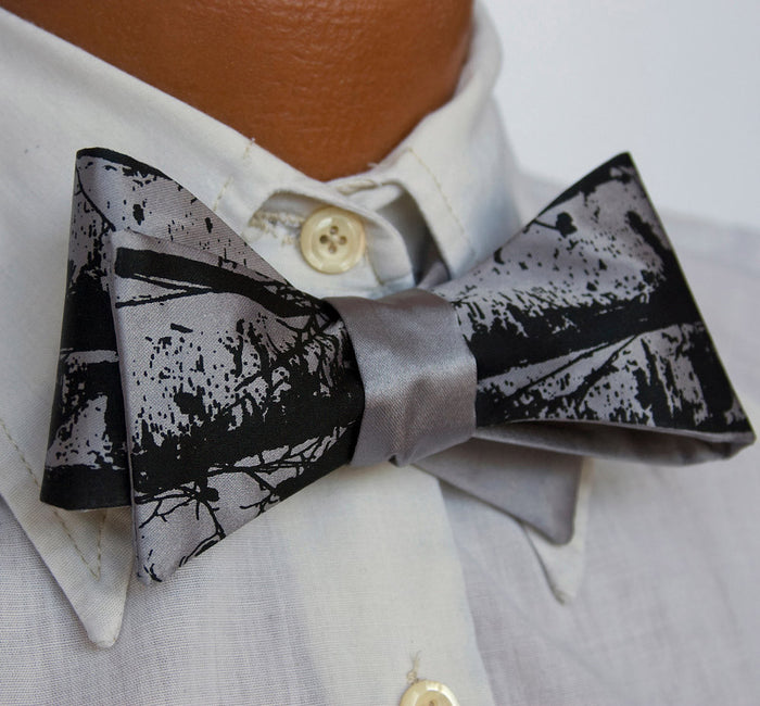 Black ink on silver bow tie.