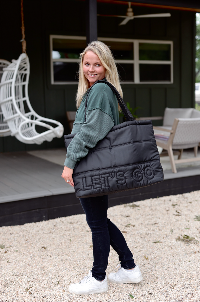 Black puffer tote bag with 'LET'S GO' text, stylish and spacious, perfect for everyday use.