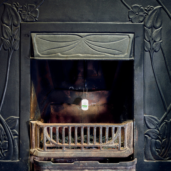 Chimney Sheep handle and safety tag hanging down from a fireplace.
