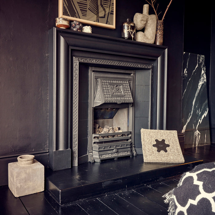 Removable chimney draught blocker by the side of a fireplace.