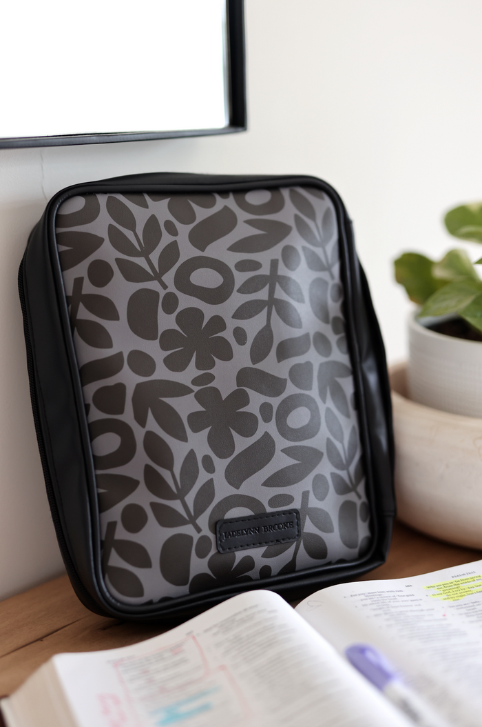 Stylish gray laptop sleeve with floral design, made from durable material, perfect for protection and organization.