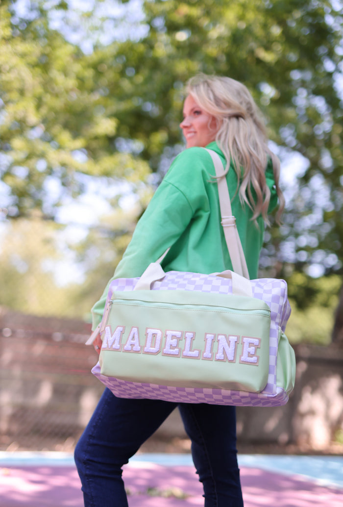 Personalized green and lavender checked duffel bag with name 'MADELINE', perfect for travel or gym.