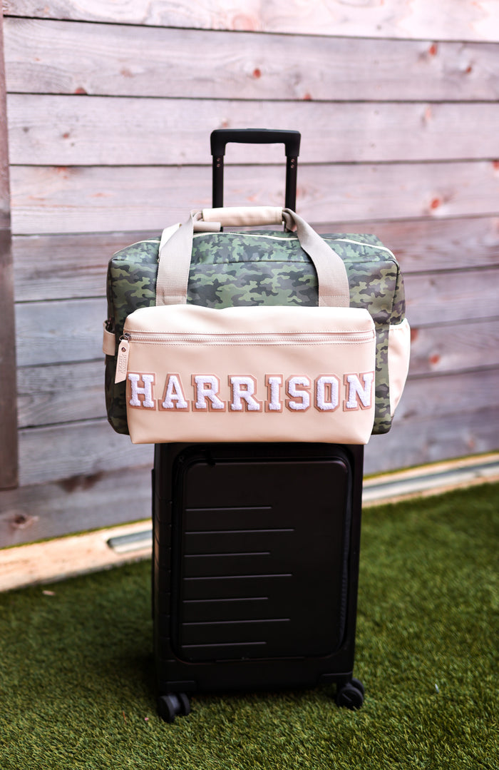 Camo duffel bag with personalized 'HARRISON' design on beige front, perfect for travel and stylish storage.