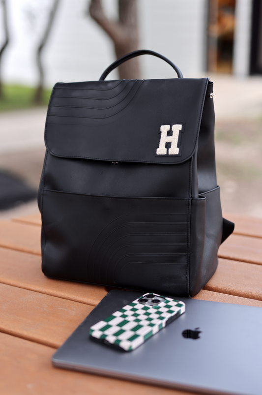 Stylish black backpack with embossed design and letter H, perfect for daily use.