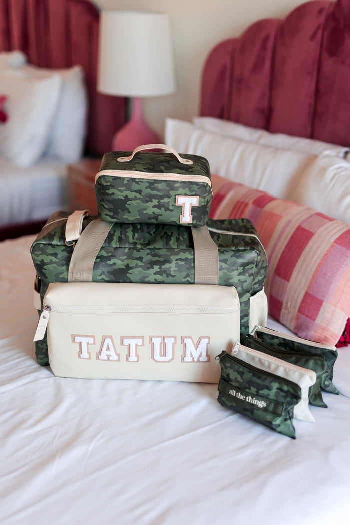 Camouflage travel bag set, featuring a larger bag with 'TATUM' and matching cases, perfect for organized trips.