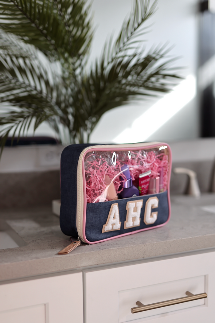 Denim cosmetic bag with clear top, pink accents, and personalized AHC design, perfect for organizing beauty products.