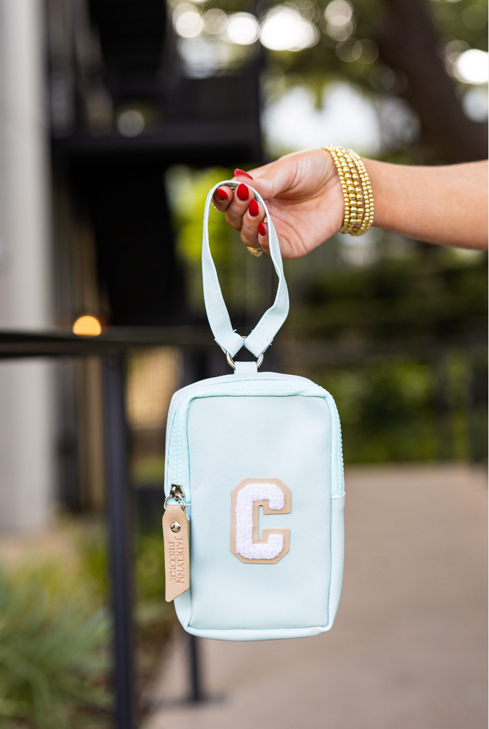 Mint green zip pouch with embroidered letter 'C' and handle, perfect for accessories or cosmetics.
