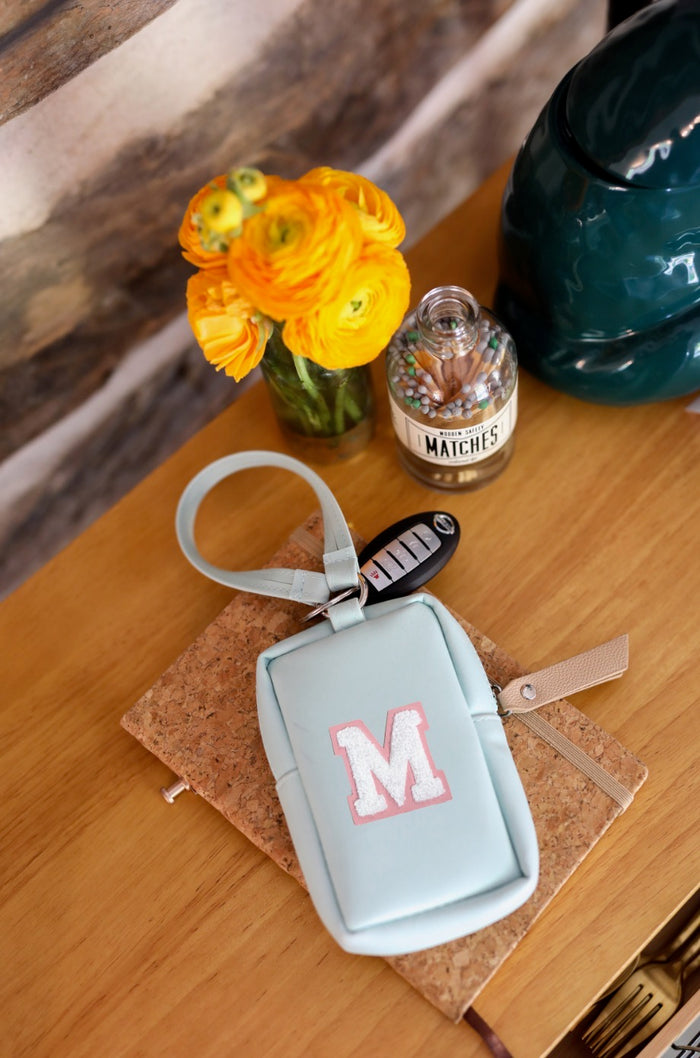 Mint green keychain holder with pink letter M, stylish and functional for organizing car keys.