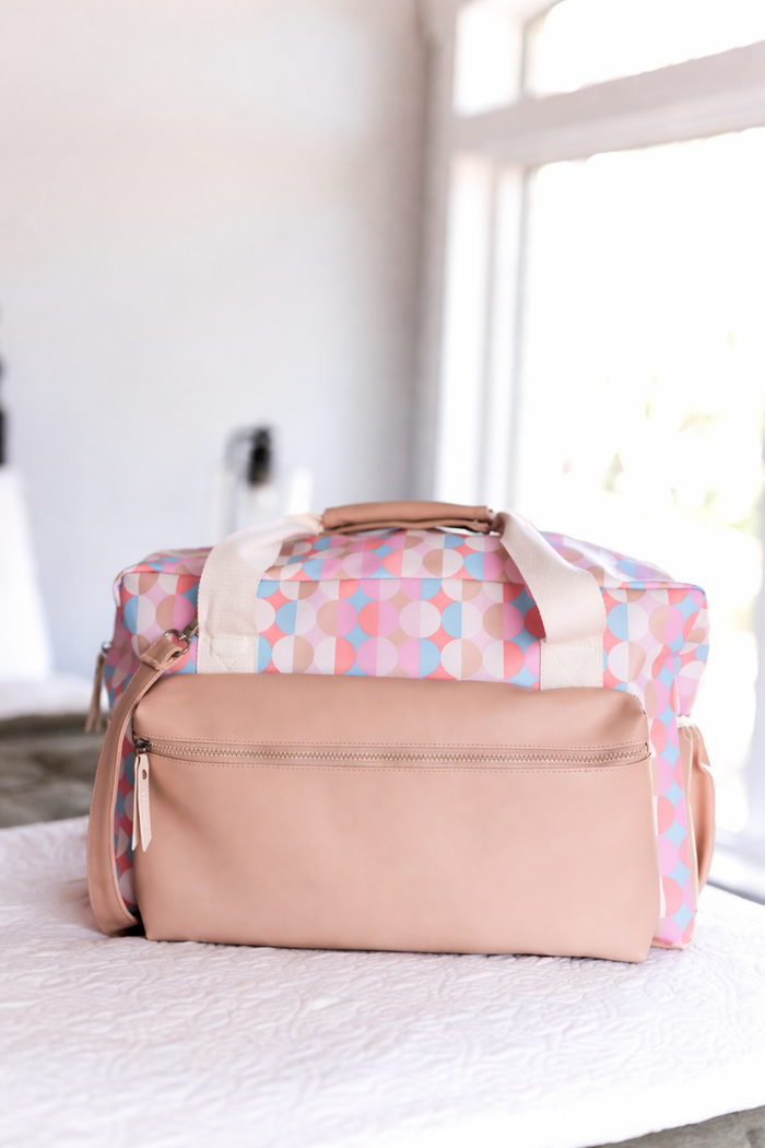 Tan and pink print duffle bag