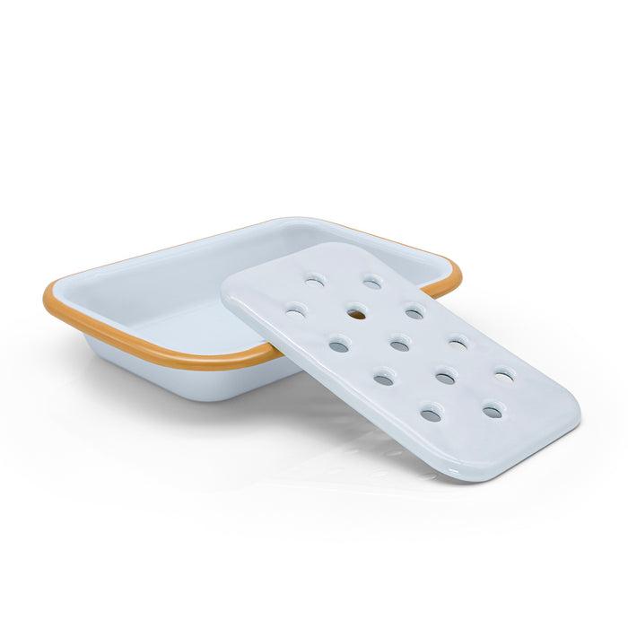 White enamel soap dish and holder with yellow rim.