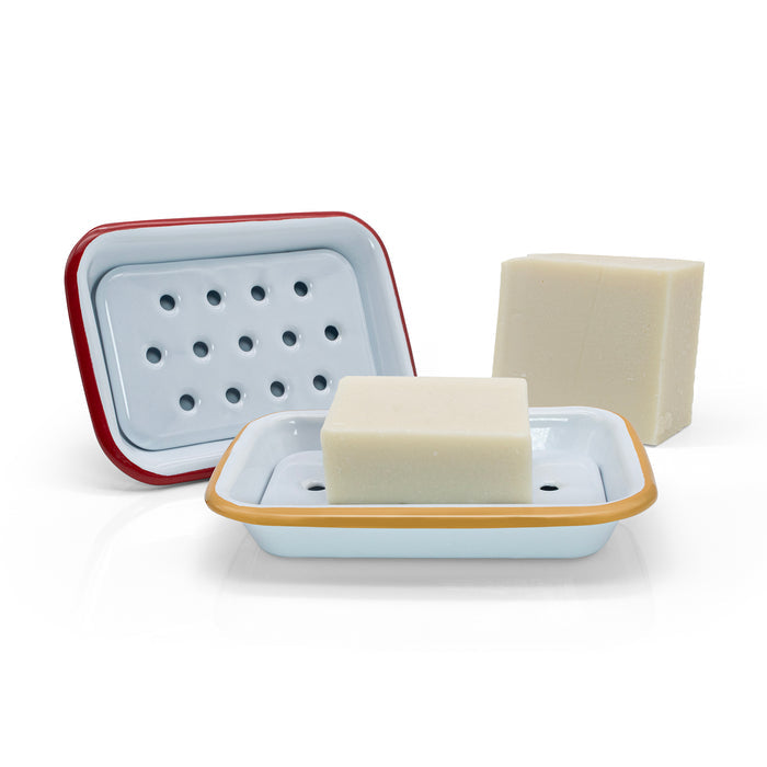 Two soap dishes with bars of soap on a white background