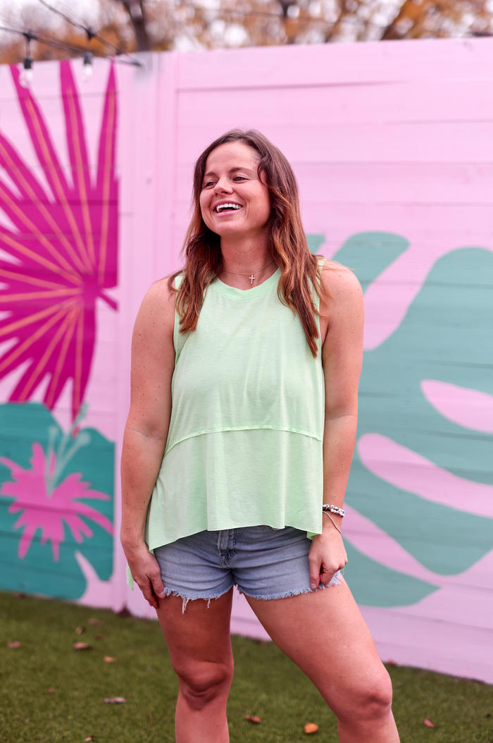 Light green sleeveless top paired with denim shorts, perfect for casual summer outings.