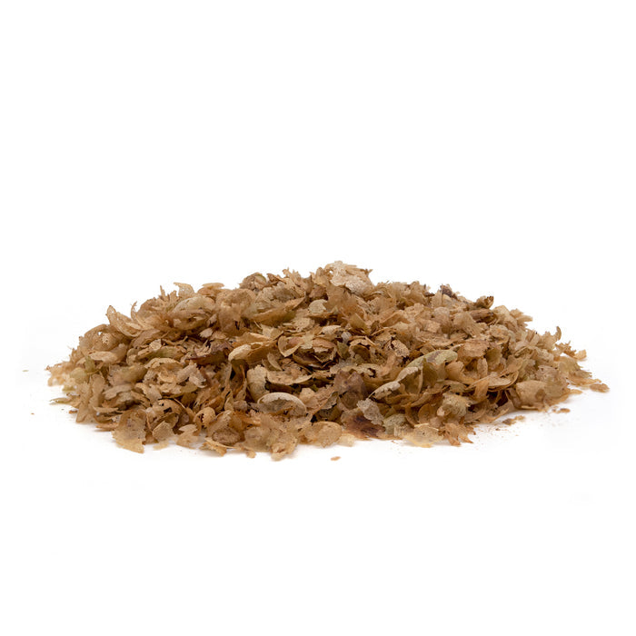 Close up of coffee chaff for gardeners - on a white background.