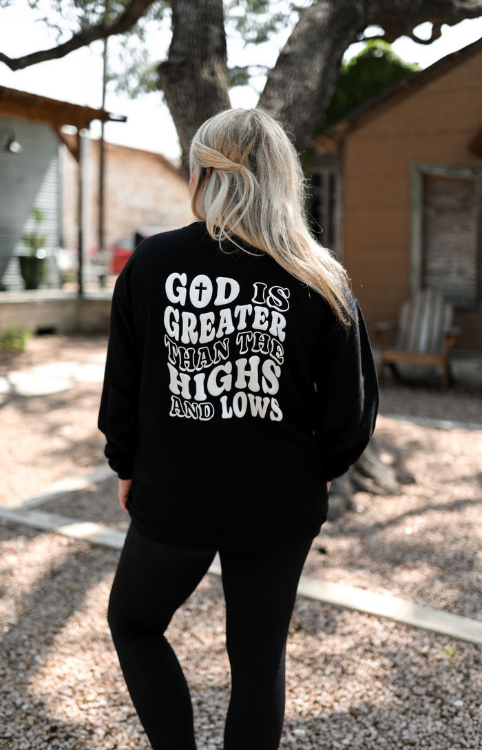 Black long sleeve shirt with 'God is greater than the highs and lows' graphic on the back.