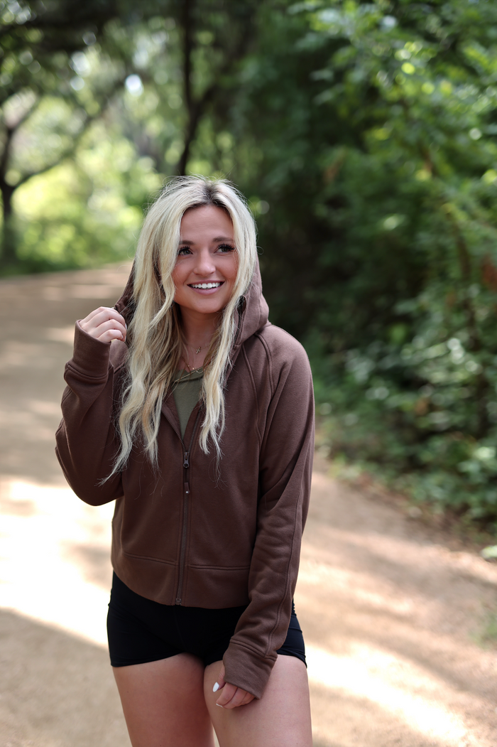 Brown zip-up hoodie made of soft material, perfect for outdoor activities and casual wear.