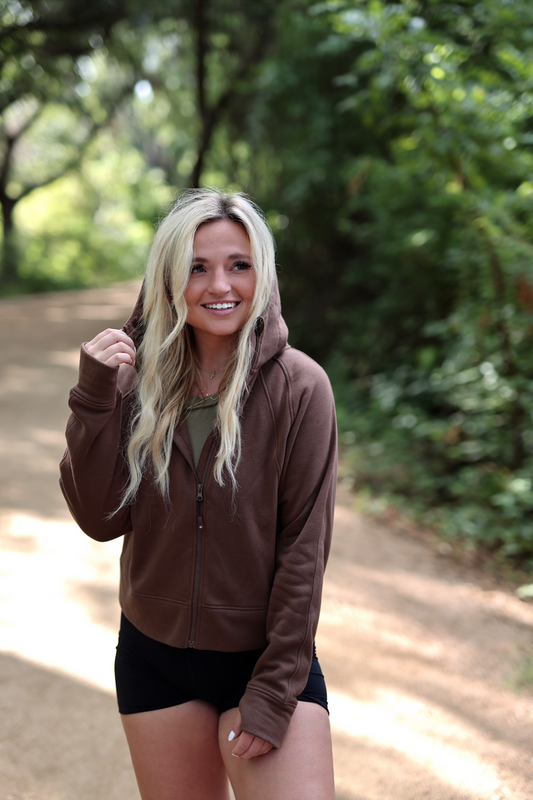 Brown zip-up hoodie made of soft material, perfect for outdoor activities and casual wear.