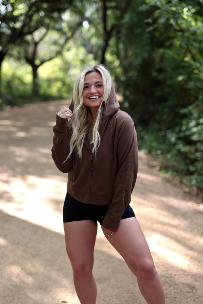Brown zip-up hoodie made from soft material, perfect for casual outdoor wear.
