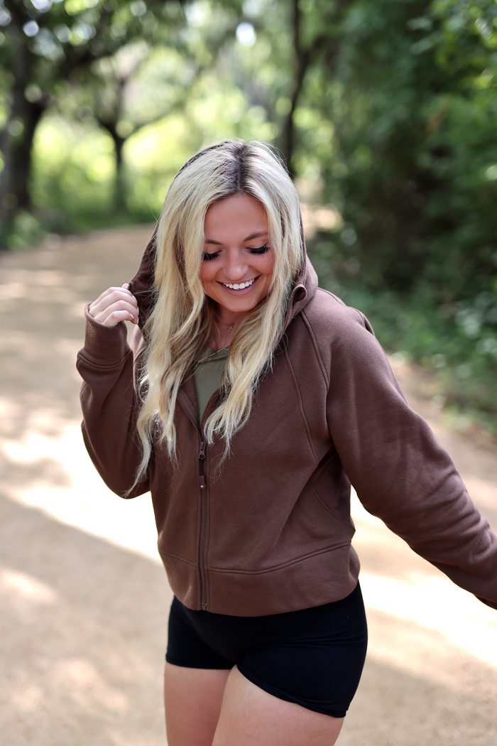 Cozy brown zip-up hoodie made from soft fabric, perfect for casual wear or outdoor activities.